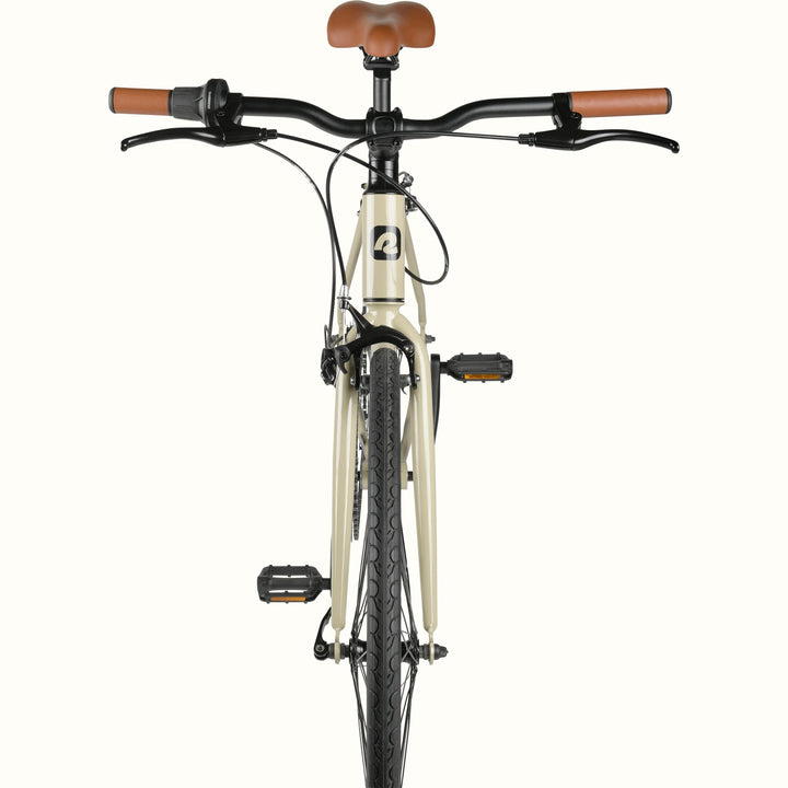 Front view of a cream-colored retrospec Harper Plus 7-Speed bicycle with brown handlebars and seat, isolated on a white background.
