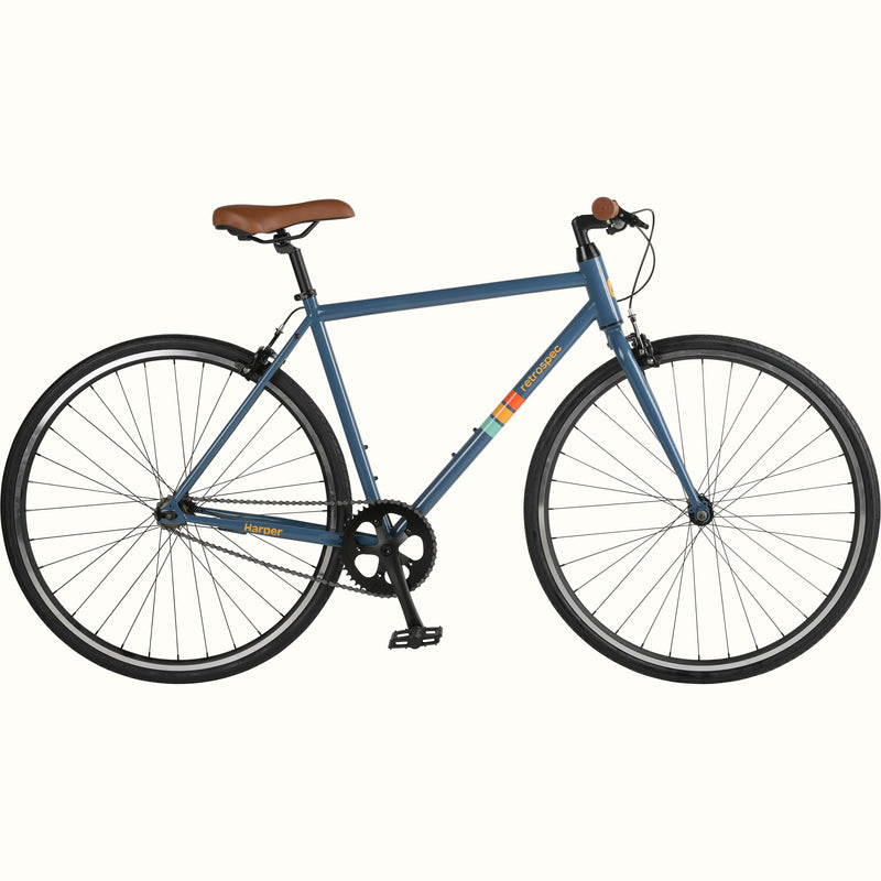 A side view of the blue Harper Fixie Single Speed bicycle with brown saddle and grips on a white background.